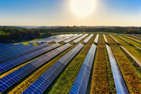 Aerial view of a solar farm in Red Wing, MN, with solar panels harnessing the sun's energy.